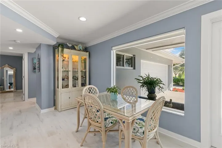 Dining area with recessed lighting, light wood-style floors, baseboards, and ornamental molding