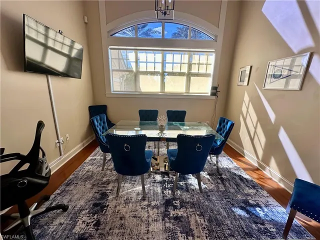 Dining space with wood finished floors and a chandelier