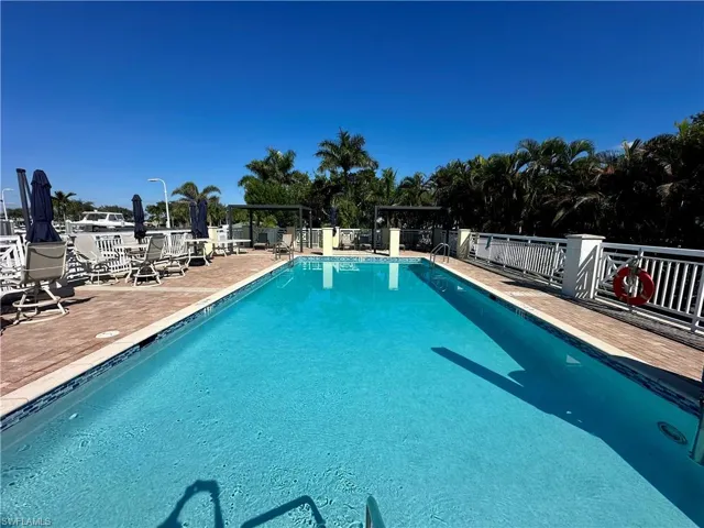 Community pool with a patio