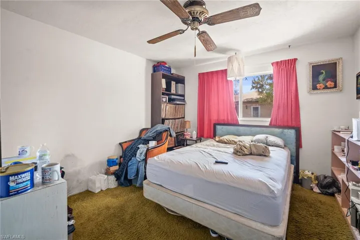 Bedroom featuring ceiling fan and carpet flooring