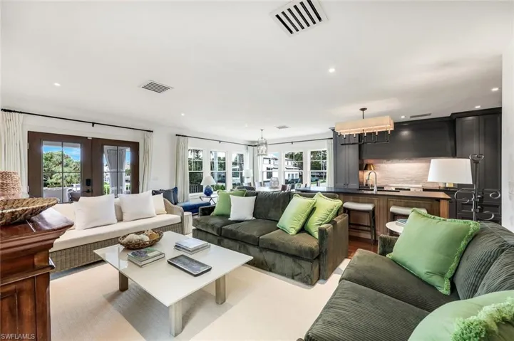 Living area featuring recessed lighting, visible vents, and french doors