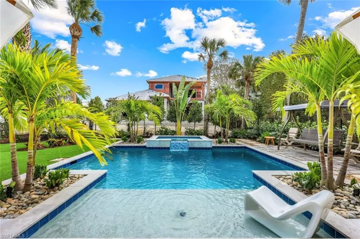 View of pool featuring a pool with connected hot tub