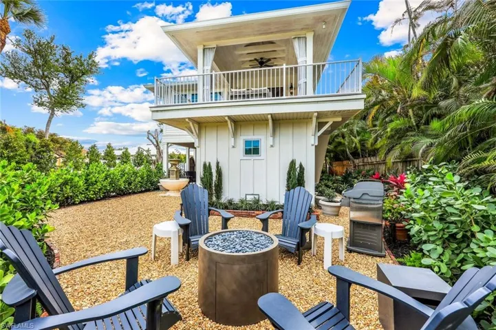 View of patio / terrace with a balcony, a grill, and fence