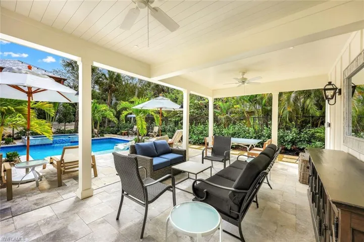 View of patio with outdoor lounge area and a pool with connected hot tub