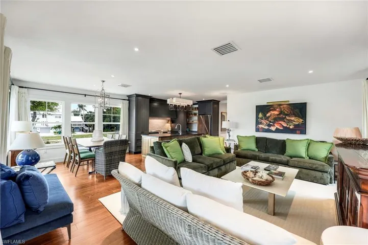 Living room featuring recessed lighting, visible vents, a chandelier, and light wood-type flooring