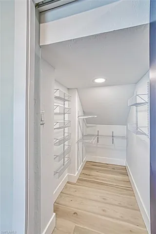Spacious closet with light wood finished floors
