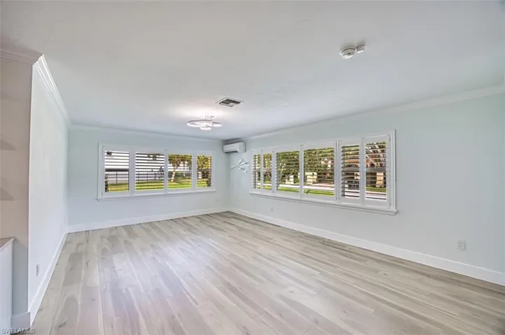 Unfurnished dining area with a chandelier, light wood-type flooring, visible vents, and baseboards