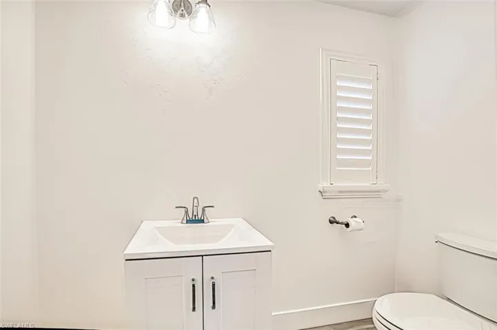 Half bath featuring vanity and toilet