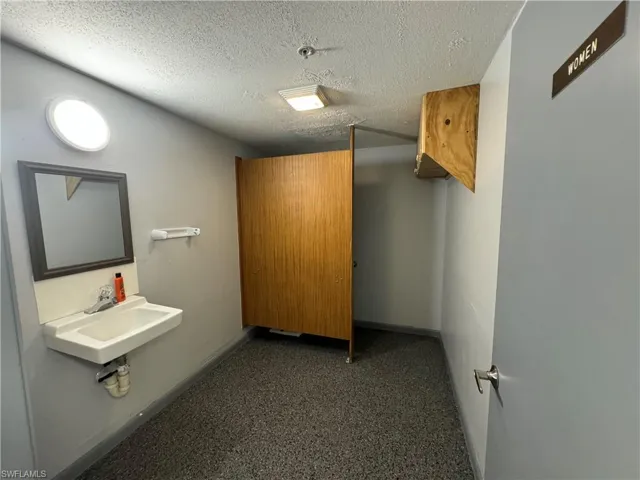 Bathroom featuring a textured ceiling and sink