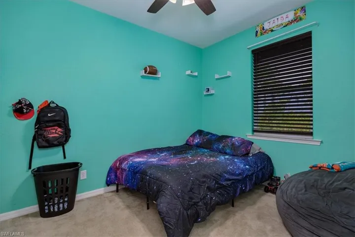 Bedroom featuring carpet and a ceiling fan