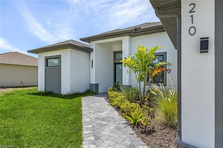 Doorway to property with a lawn