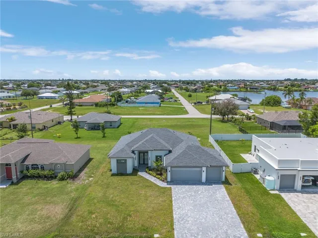 Birds eye view of property with a water view