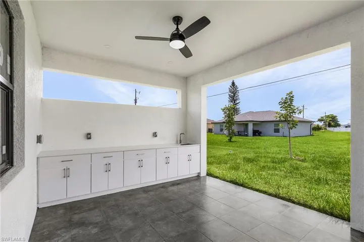 View of patio with sink and ceiling fan