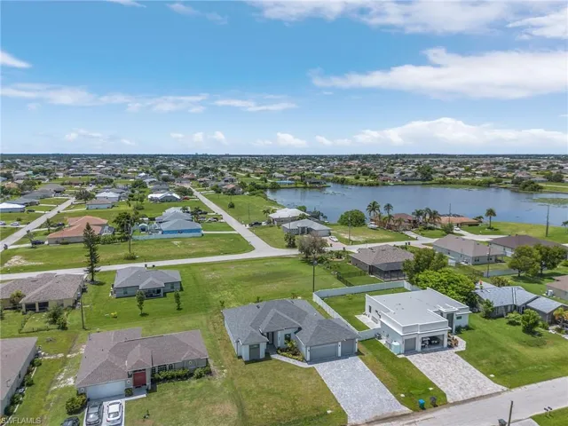 Birds eye view of property with a water view