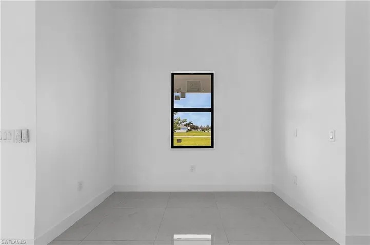 Spare room with light tile patterned flooring
