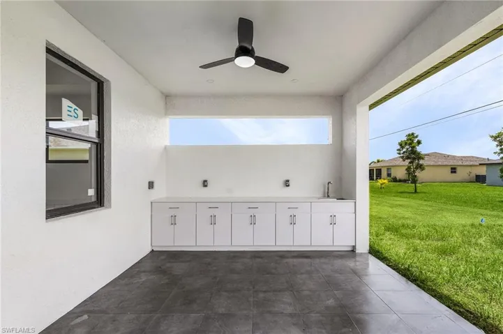 View of patio with sink and ceiling fan