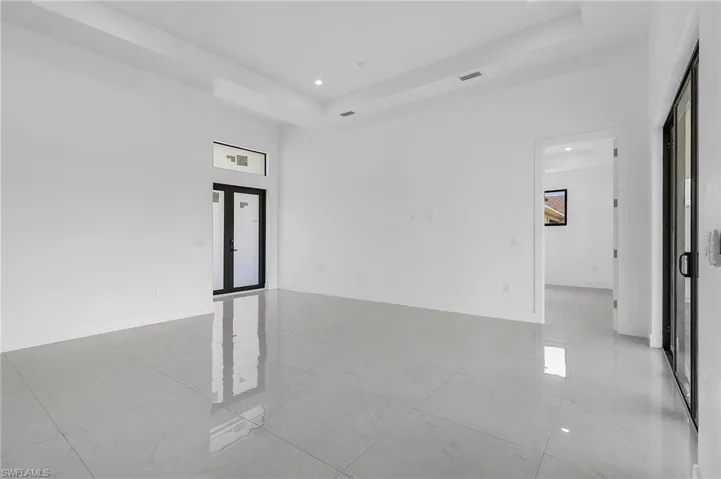 Spare room featuring light tile patterned flooring and a raised ceiling