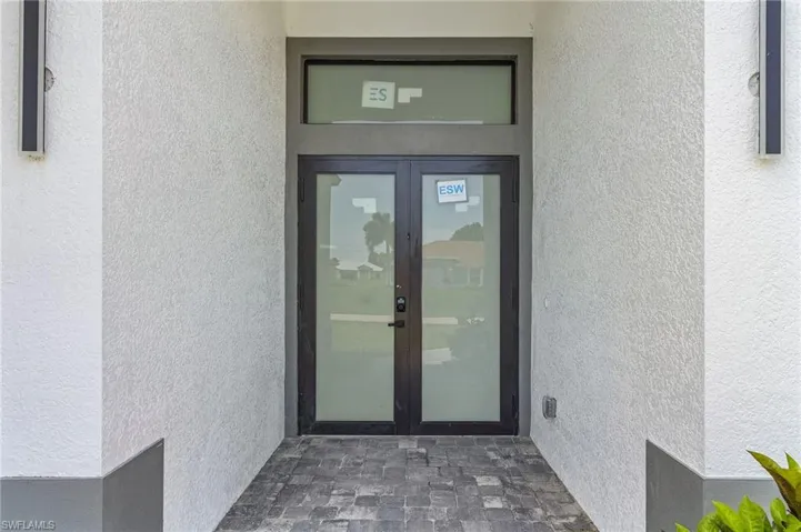 Property entrance featuring french doors