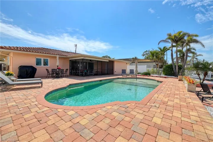 View of pool with fence, a sunroom, a patio, and a fenced in pool