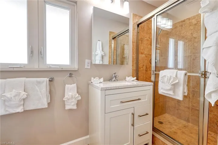 Bathroom featuring a stall shower and vanity