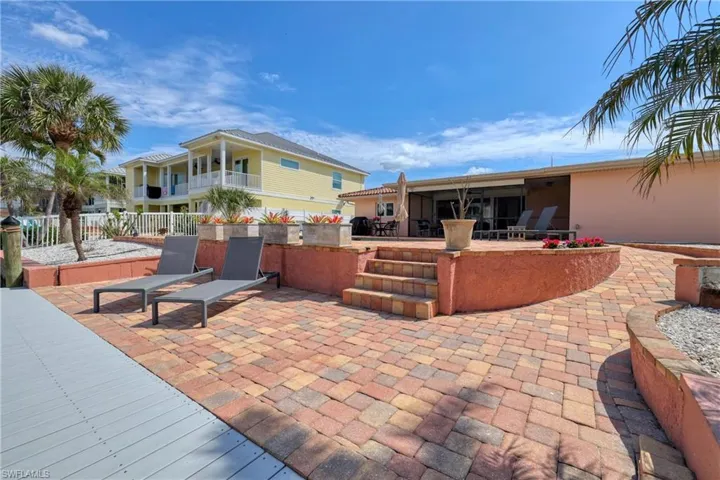 View of patio featuring fence