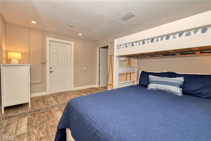 Bedroom with recessed lighting, visible vents, baseboards, and wood finished floors