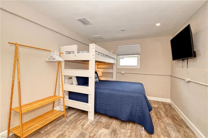 Bedroom with wood finished floors, recessed lighting, baseboards, and visible vents