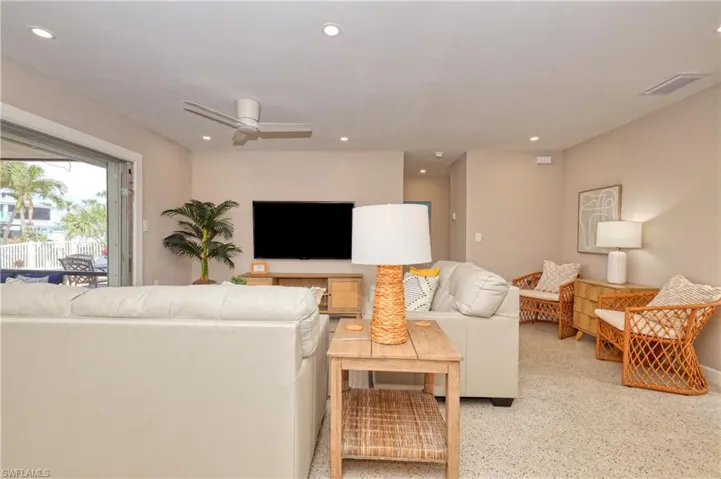 Living room featuring speckled floor, visible vents, recessed lighting, and a ceiling fan