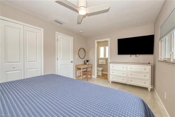 Unfurnished bedroom with baseboards, visible vents, a closet, and light speckled floor