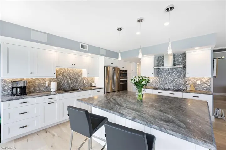 Large center island with extra storage and breakfast bar.