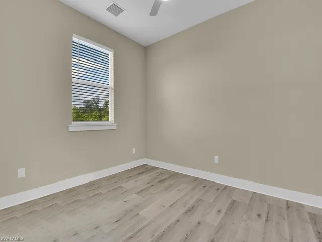 Spare room with light wood-type flooring and ceiling fan