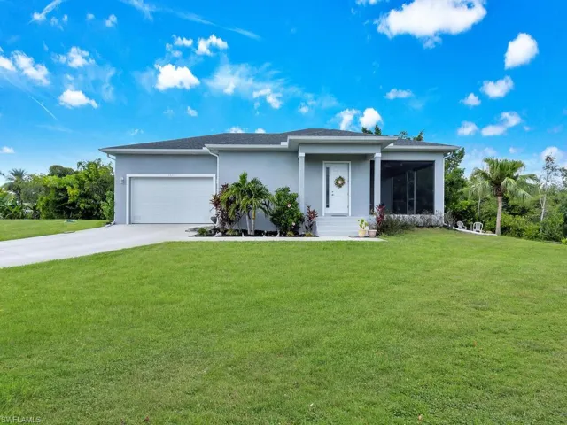 View of front of home featuring a garage and a front lawn