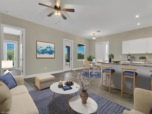 Living room with ceiling fan, sink, and light hardwood / wood-style flooring
