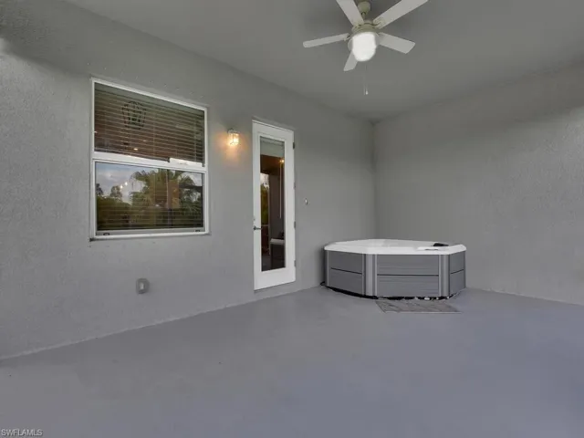 View of Screened Lanai with ceiling fan and hot tub