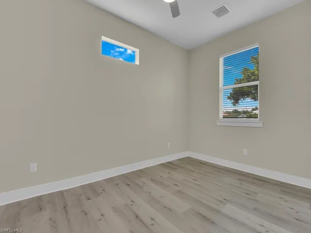 Spare room featuring light wood-type flooring and ceiling fan