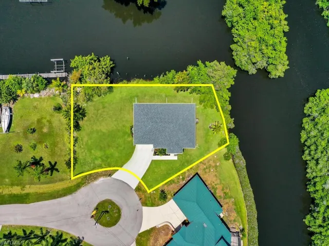 Birds eye view of property with a water view