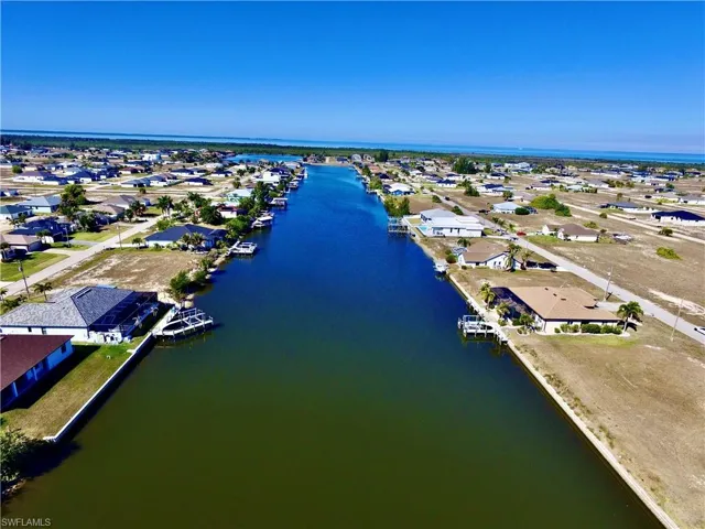 Aerial view of property's location with nearby suburban area and a nearby body of water