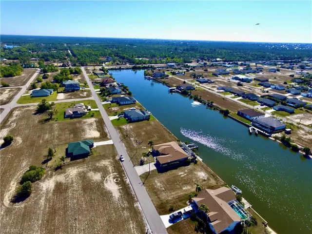 Aerial view of property's location featuring nearby suburban area and a large body of water