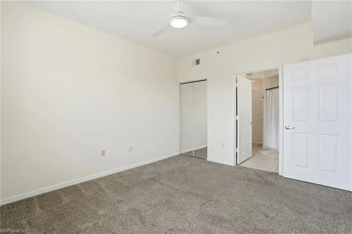 Unfurnished bedroom with a closet, carpet flooring, and a ceiling fan