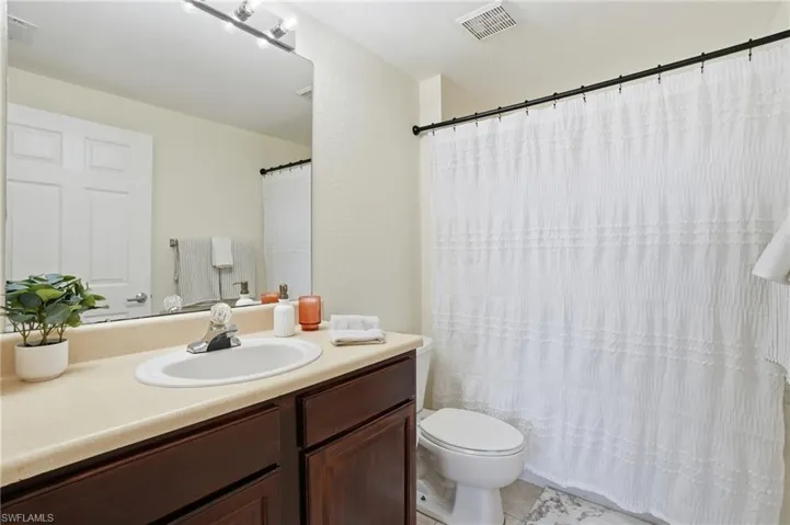 Full bathroom with vanity and a shower with curtain