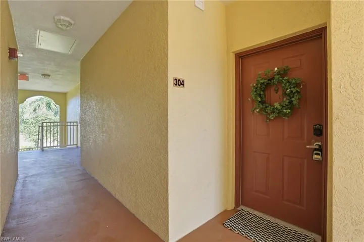 Property entrance featuring stucco siding