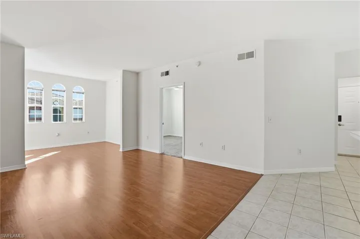 Spare room featuring light wood-style flooring and baseboards