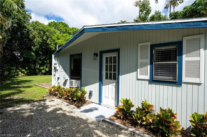 Side Entrance to property with a yard