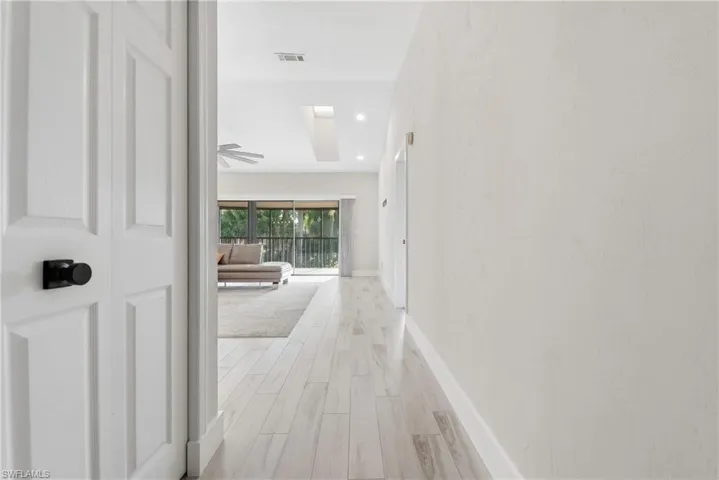 Light wood-finish flooring extending through the living areas