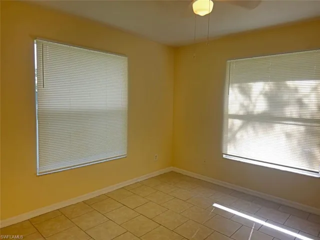 Spare room with light tile patterned flooring and ceiling fan