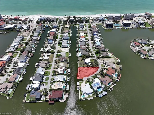 View of property location featuring a large body of water and nearby suburban area