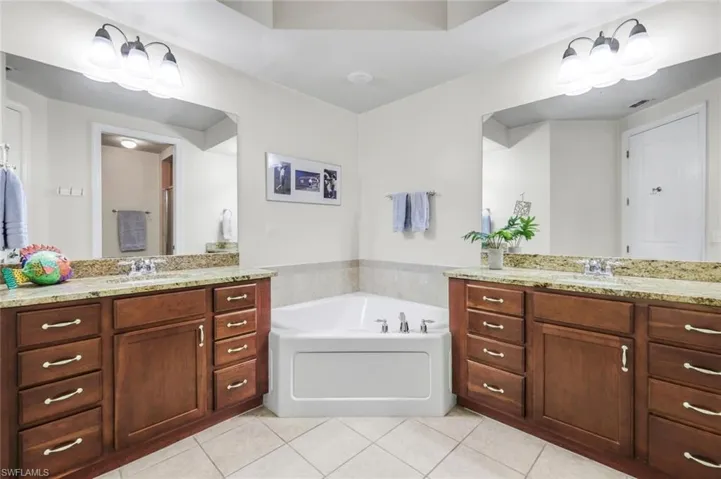 Bathtub and shower with double vanities.