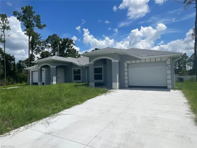 Ranch-style home with an attached garage, stucco siding, and concrete driveway