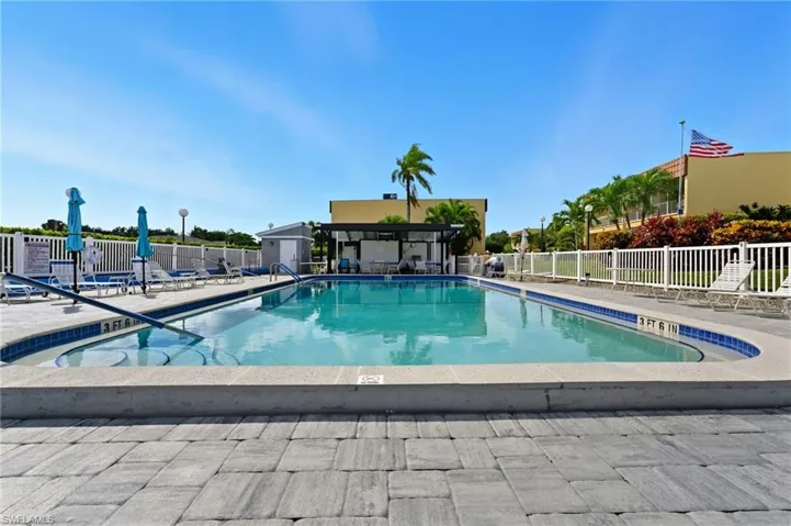 Community pool with a patio