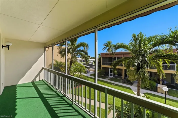 Balcony featuring a sunroom